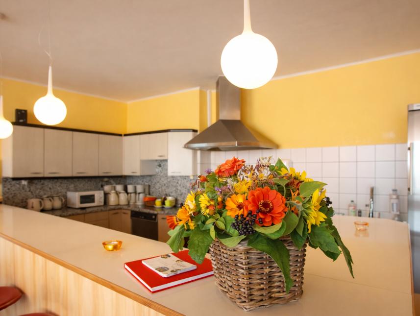 Die offene Küche mit großem Gasherd und viele Kühlschränke.